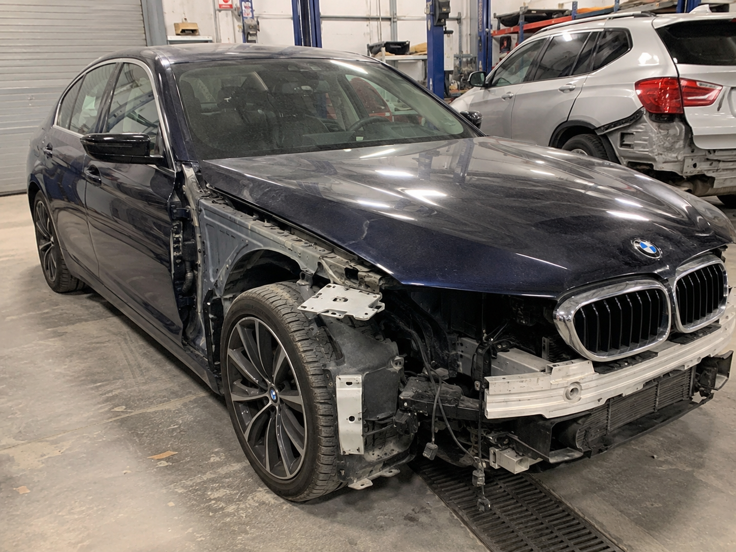 BMW 3 Series before collision repair, showing damage